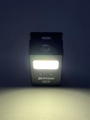SPERAS U1 clip light illuminating the dark with its wide flood beam, perfect for close-up tasks or serving as a powerful hands-free headlamp.