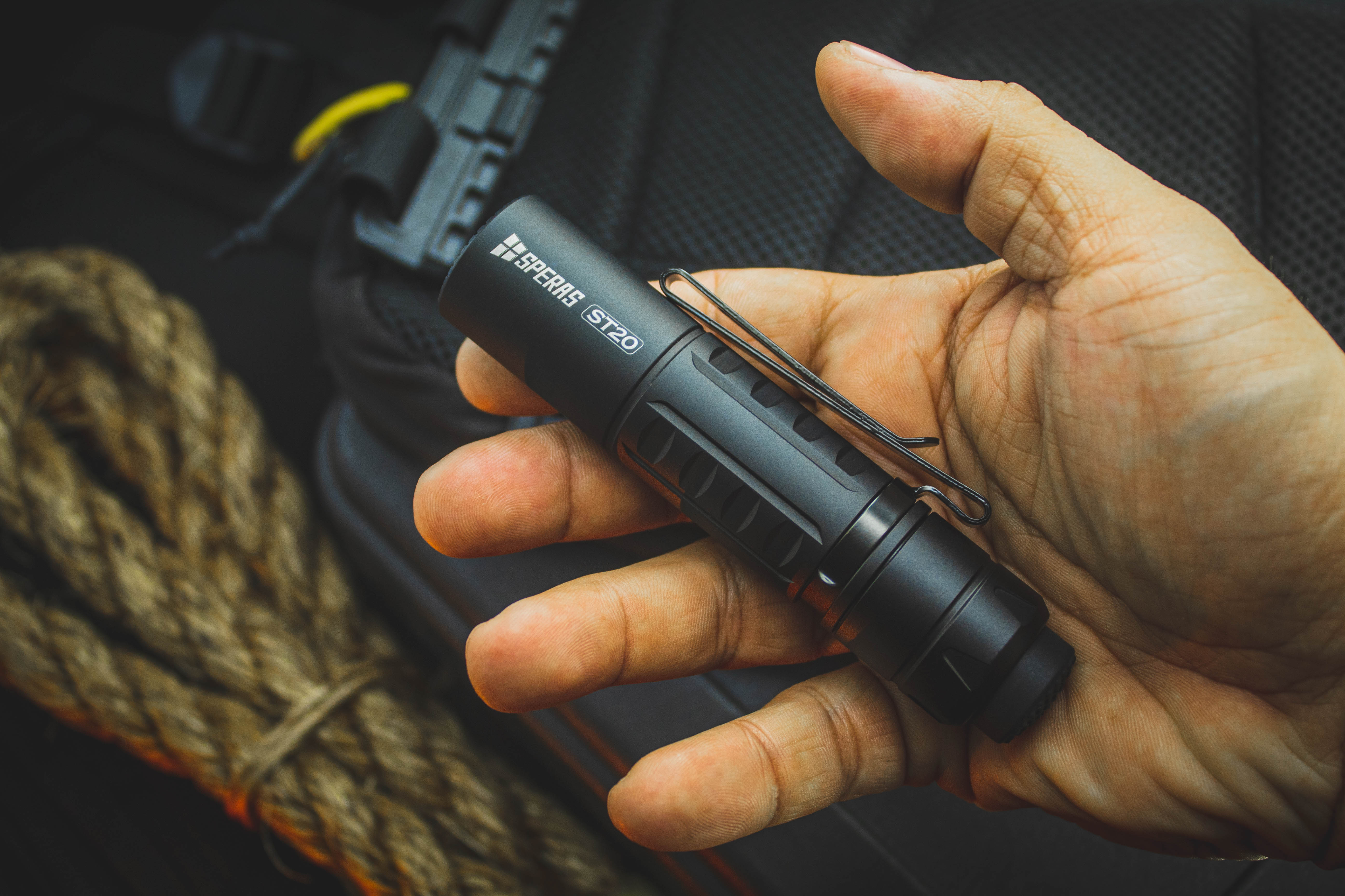 Ultra compact 115mm SPERAS ST20 EDC flashlight held in hand highlighting its heavy duty double sided pocket clip