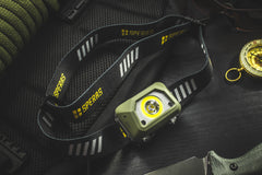 SPERAS B9 600-lumen outdoor hiking headlamp with bright spotlight active on tactical gear