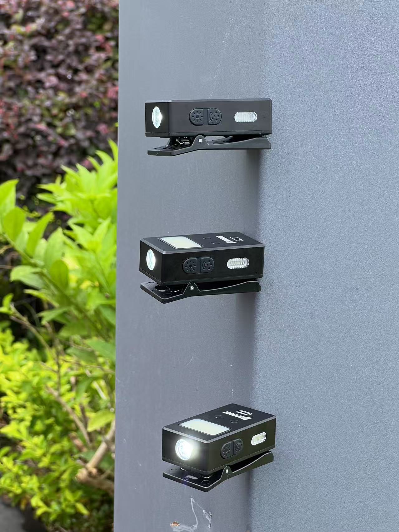 Multiple SPERAS U1 clip lights magnetically attached to a metal pillar, showcasing its strong magnetic base for hands-free EDC flashlight utility.