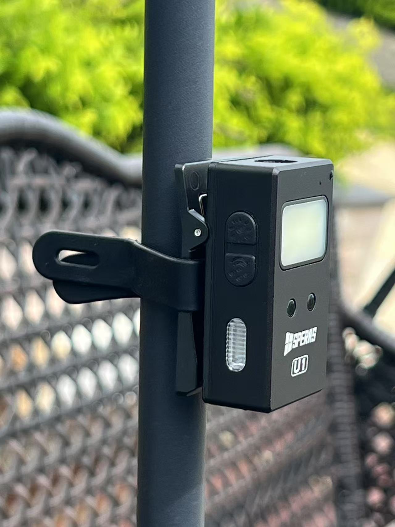 SPERAS U1 versatile clip light securely mounted to a pole, demonstrating its heavy-duty clamp for hands-free EDC flashlight and outdoor use.